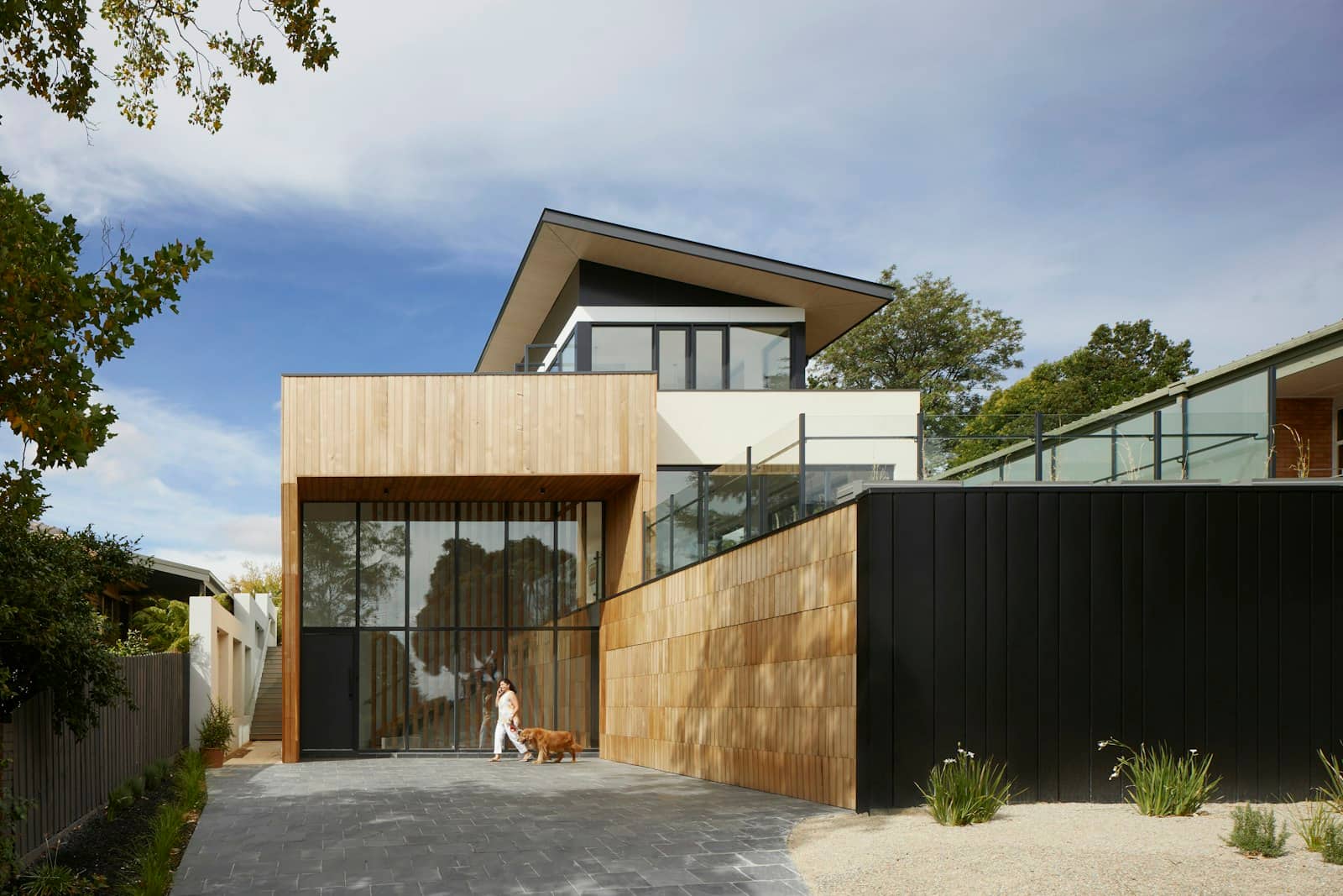 Timber-clad modern home with cantilevered upper storey